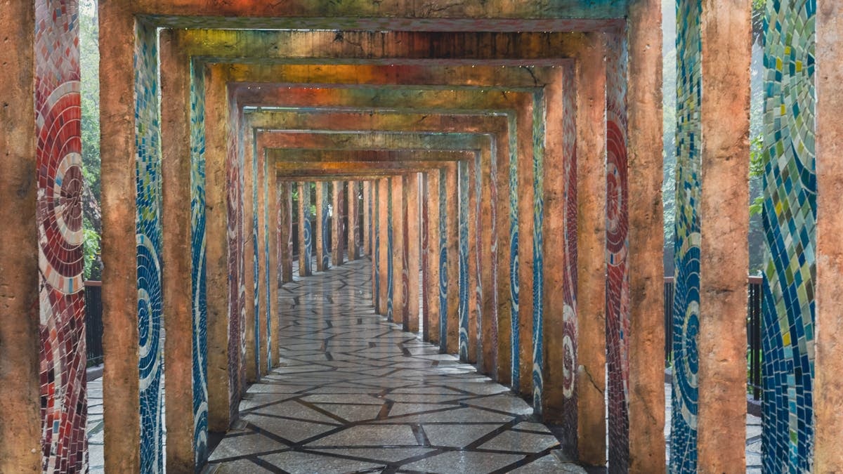 A vibrant mosaic corridor with geometric paving stones in Ba Na Hills, Vietnam.